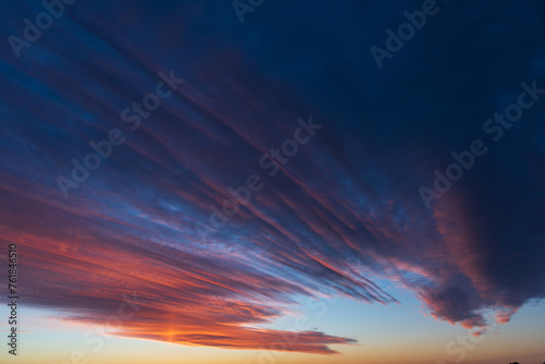 Stunningly beautiful multi-colored violet-pink-lilac evening sky, multi-colored clouds fan out from the lower horizon