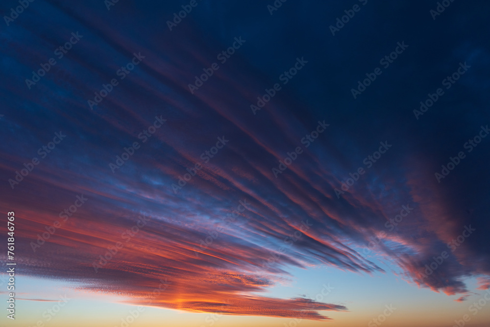 Stunningly beautiful multi-colored violet-pink-lilac evening sky, multi-colored clouds fan out from the lower horizon