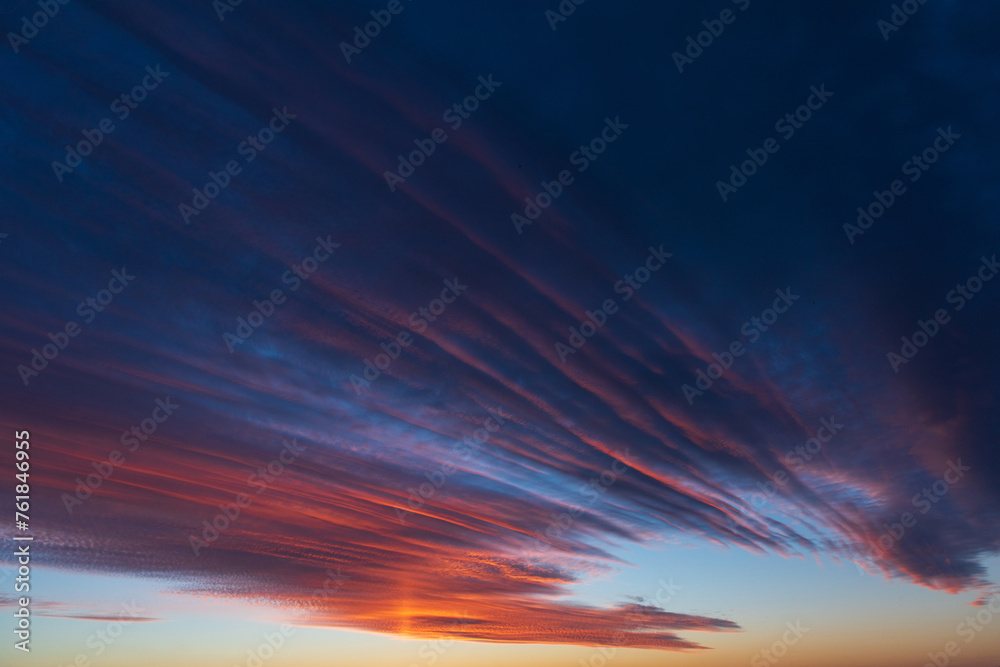 Stunningly beautiful multi-colored violet-pink-lilac evening sky, multi-colored clouds fan out from the lower horizon