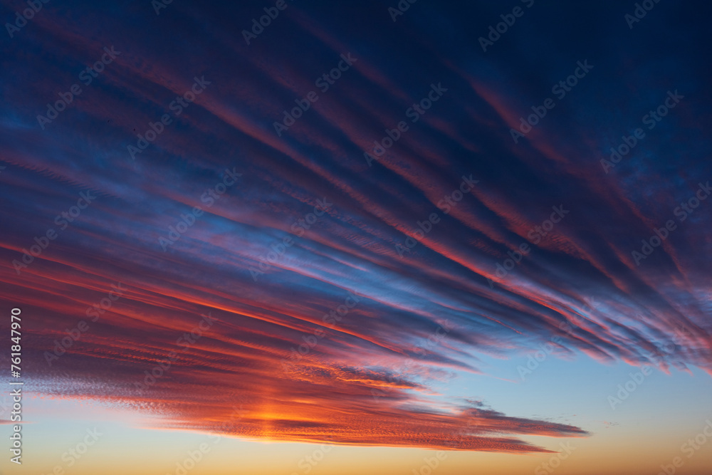 Stunningly beautiful multi-colored violet-pink-lilac evening sky, multi-colored clouds fan out from the lower horizon