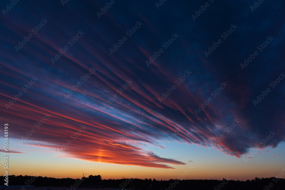 Stunningly beautiful multi-colored violet-pink-lilac evening sky, multi-colored clouds fan out from the lower horizon