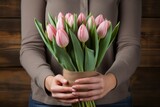 Women's hands are holding a bouquet of tulips. International Women's Day 8 march