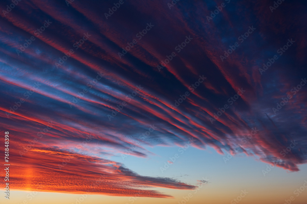 Stunningly beautiful multi-colored violet-pink-lilac evening sky, multi-colored clouds fan out from the lower horizon