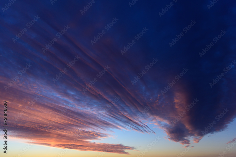 Stunningly beautiful multi-colored violet-pink-lilac evening sky, multi-colored clouds fan out from the lower horizon