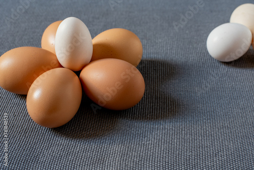 Fresh brown and small chabo chicken eggs on grey background. photo