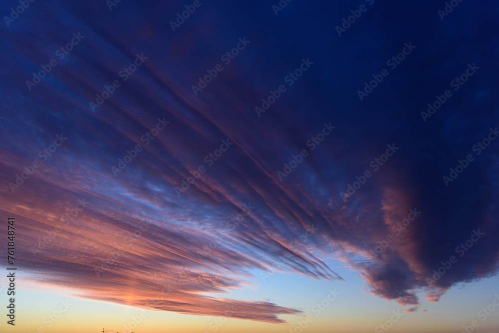 Stunningly beautiful multi-colored violet-pink-lilac evening sky, multi-colored clouds fan out from the lower horizon
