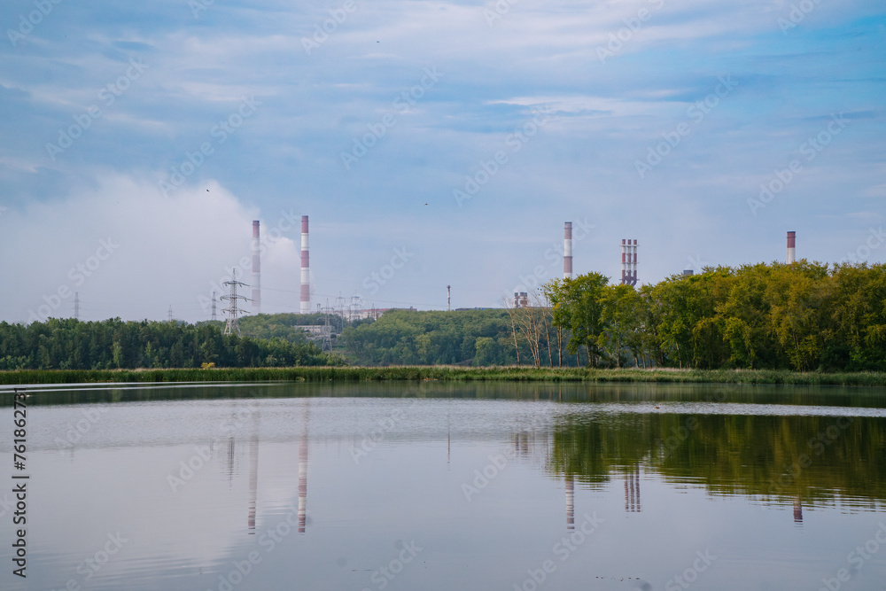 River Dividing Green Village and Factory with Large Emitting Chimneys River Dividing Green Village and Factory with Large Emitting Chimneys