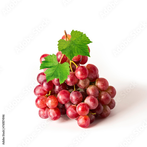 Bunch of red grapes with leaves on white background.
