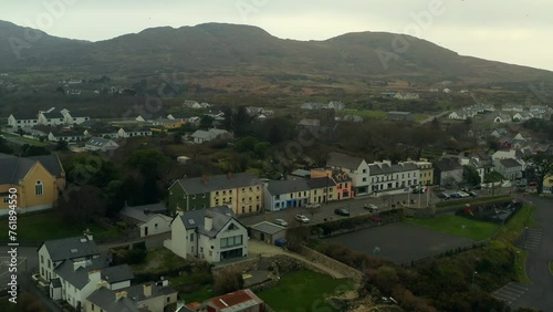 Aerial pullback of Roundstone town in Connemara featuring the mountains in the background. photo