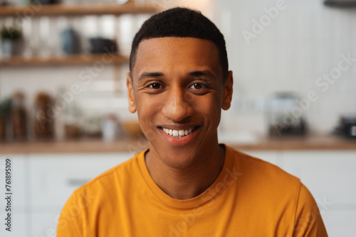Portrait of smiling authentic African American man, confident businessman wearing yellow t shirt