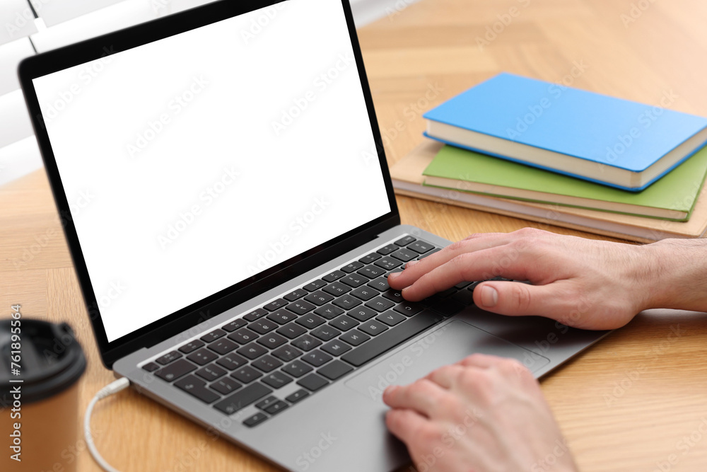 E-learning. Man using laptop during online lesson at table indoors, closeup E-learning. Man using laptop during online lesson at table indoors, closeup