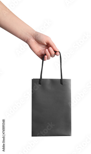 Woman holding paper shopping bag on white background, closeup