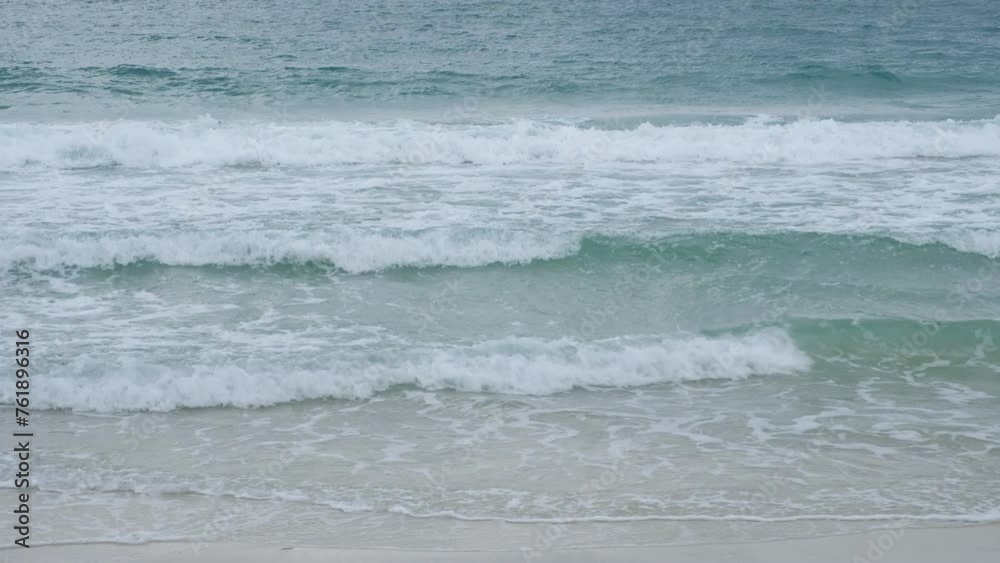 Closeup blue waves crashing on the brown sandy beach. Closeup blue waves crashing on the brown sandy beach.