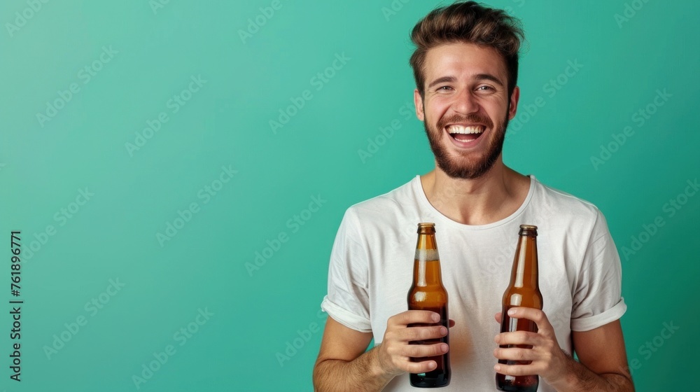 Portrait of cheerful funky young man open mouth hands hold glass beer bottles isolated on green color background,copy space. Portrait of cheerful funky young man open mouth hands hold glass beer bottles isolated on green color background,copy space.