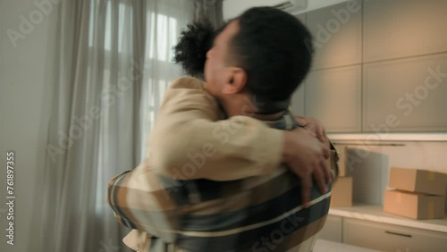 Happy family African American love couple home owners moving in new apartment joyful boyfriend girlfriend hugging celebrate relocation cheerful man woman buying renting house real estate mortgage loan