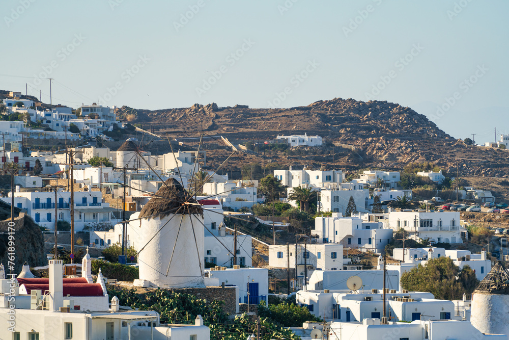 Mykonos cityscape with traditional windmill seen from the distance. Greece
