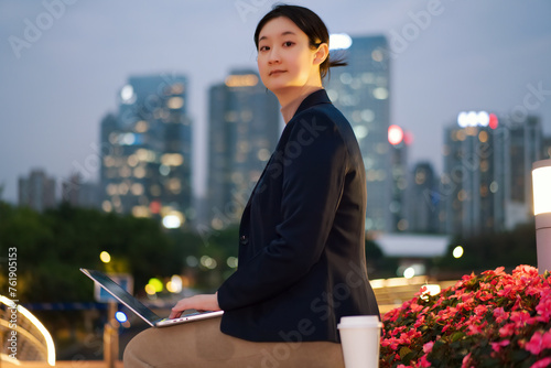 Young Businesswoman Working on Laptop Outdoors