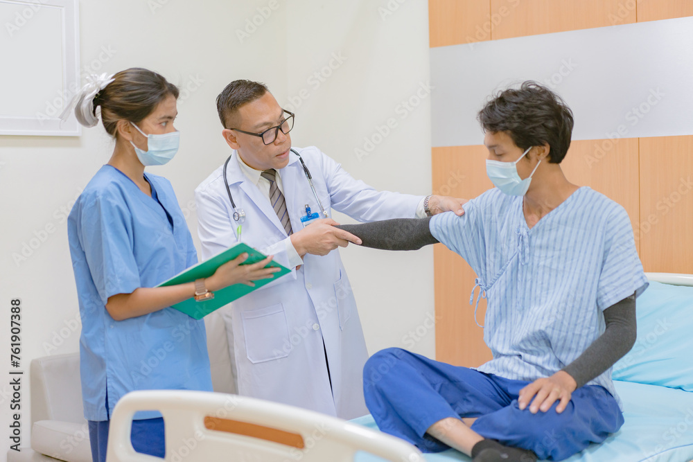 Doctor checking blood pressure to a patient. The doctor is inserting a device into the arm to measure blood pressure for a physical examination. Doctor checking blood pressure to a patient. The doctor is inserting a device into the arm to measure blood pressure for a physical examination.