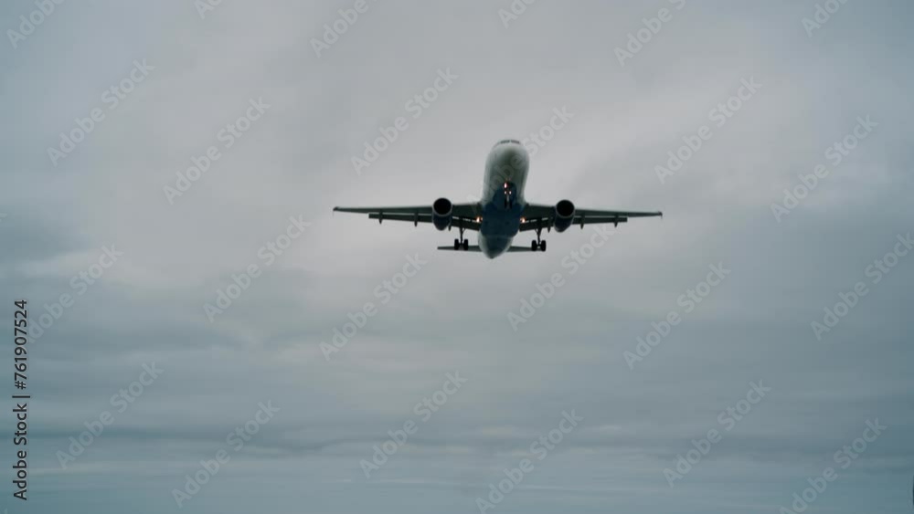 Airplane in slow motion against a background of cloudy weather. Airplane in slow motion against a background of cloudy weather.