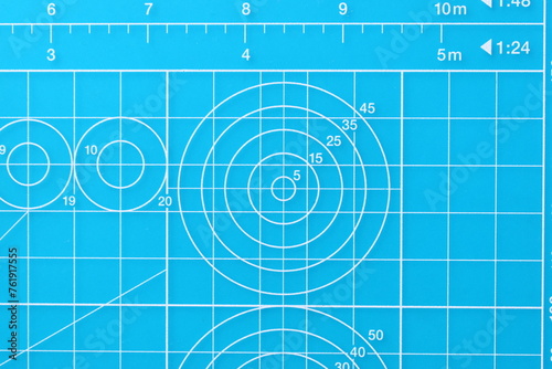 blue cutting mat board background with line and scale measure guide pattern for object art design, tool equipment of diy craft work