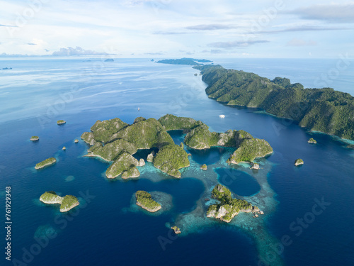 Beautiful limestone islands rise from Raja Ampat's tropical seascape. This region of Indonesia is known as the heart of the Coral Triangle due to the extraordinary marine biodiversity found there. © ead72