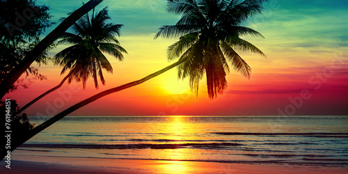 Sunset on tropical island sea beach panorama, ocean sunrise panoramic landscape, palm tree leaves silhouette, colorful orange red sky, yellow sun reflection, blue water waves, summer holiday, vacation © Vera NewSib