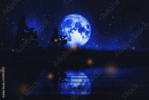 Mother and son riding a bikes full moon and grassland and calm river at nightscape © thekopmylife