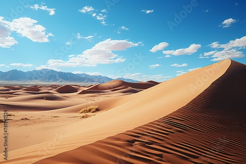 A solitary sand dune stands amidst a desert with mountains in the background