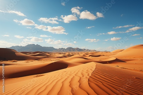 Erg landscape with towering sand dunes  mountains  and a clear sky