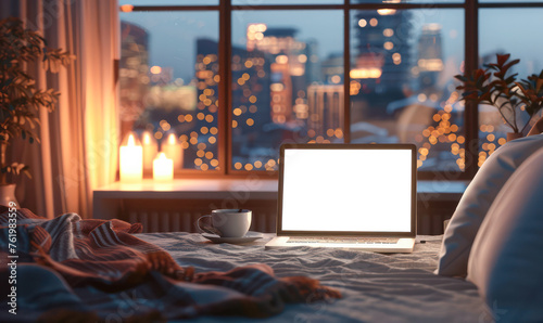 Laptop computer on white bed sheets in cozy modern hotel room with copy space blank screen and sunrise city view on the background.Generative AI