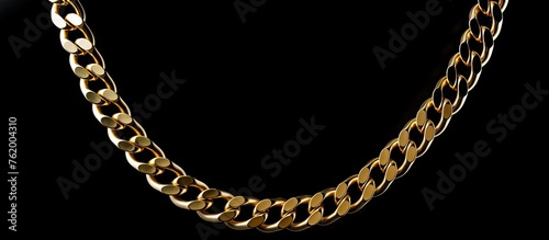 A gold chain on a black background