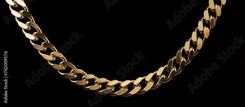 A shiny gold chain on a dark background © Ilgun