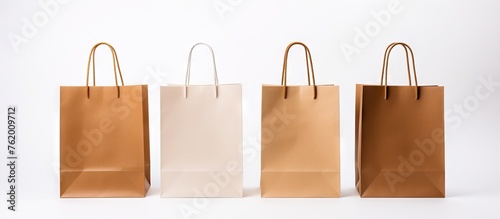 Three brown and white paper bags on wooden surface