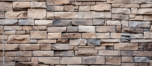 Rustic Old Stone Wall with Intricate Brown Stone Pattern Background Texture