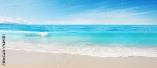 A tranquil view of a beach with an approaching wave