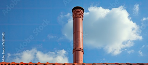 Chimney on roof under blue sky photo