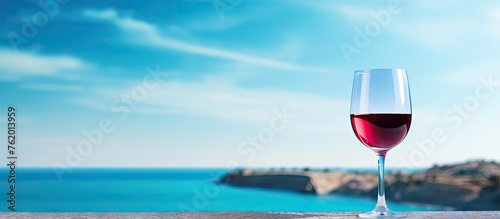 Glass of Red Wine overlooking Ocean photo