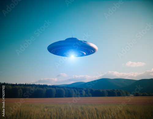 A UFO hovered high in the sky against the background of a cloud.