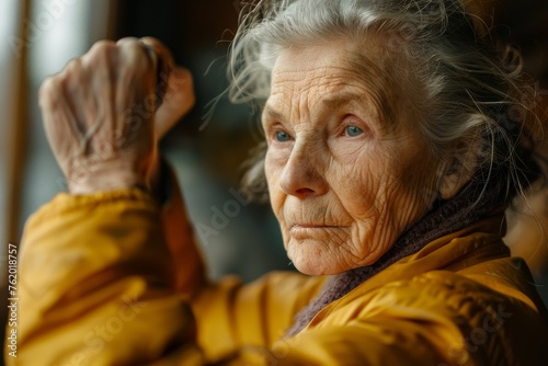 Elderly person engaging in warm-up activities, highlighting their dedication to maintaining physical fitness and well-being © Nattadesh