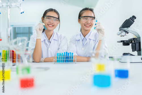 Two Asian female researchers are scientists in a biology lab. Manufacture medicines with solutions in test tubes Business industry, pharmaceutical manufacturing company, medical, pharmaceutical