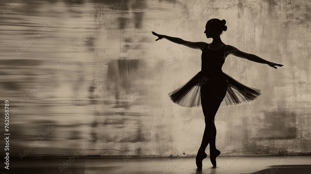 Graceful black silhouette of a ballerina in front of a wall