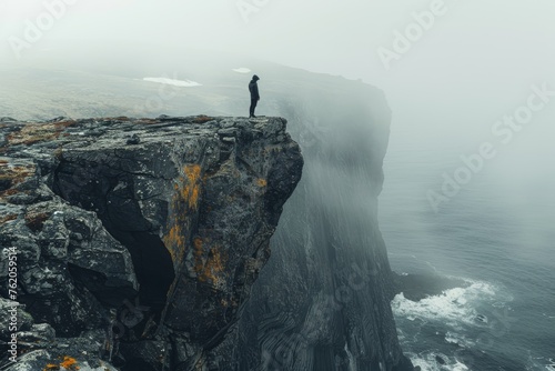 One adventurer standing precariously on the edge of a perilous cliff, evoking a sense of danger and thrill.