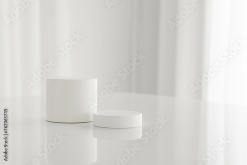 Set of white cylinder pedestal podium on white table background