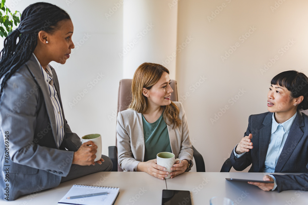 A diverse group of multi-ethnic businesswomen sit in the office and have a conversation. They engage in discussions, reflecting their entrepreneurial spirit and collaboration A diverse group of multi-ethnic businesswomen sit in the office and have a conversation. They engage in discussions, reflecting their entrepreneurial spirit and collaboration