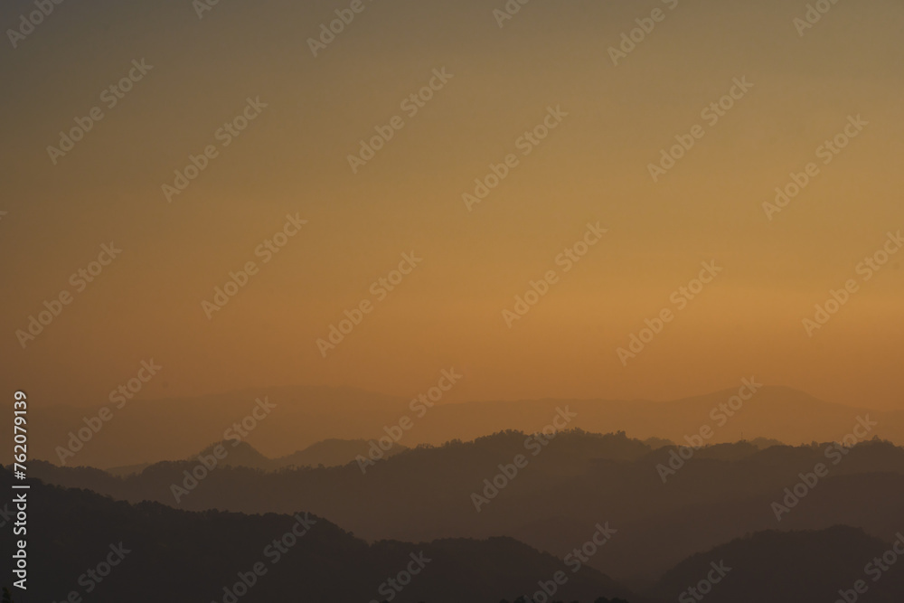 landscape and travel concept with sunset and twilight sky with layer of mountain
