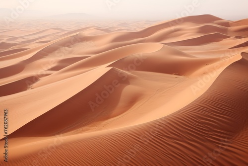  Aerial photograph showcasing the vastness of the desert, with dunes creating waves in varying shades of pastel brown, embodying desert aesthetics. © Hanna Haradzetska