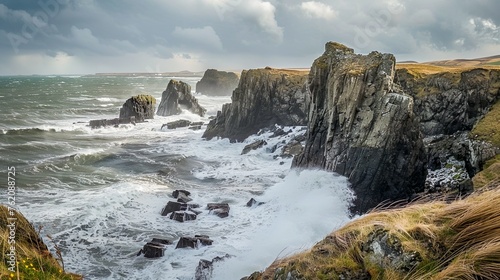 A rugged coastline dotted with sea stacks, battered by crashing waves under a stormy sky photo