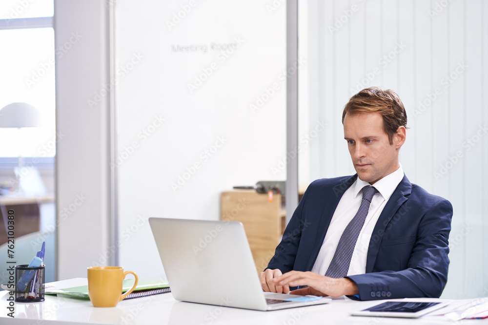 Reading, typing and man in office with laptop, sales report or email at online consulting agency. Internet, business growth or development for businessman on website for budget, planning and research