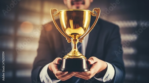 successful businessman receiving award trophy