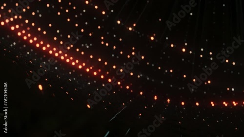 A dazzling disco ball on a stage throws colorful lights in a blurred, party atmosphere photo